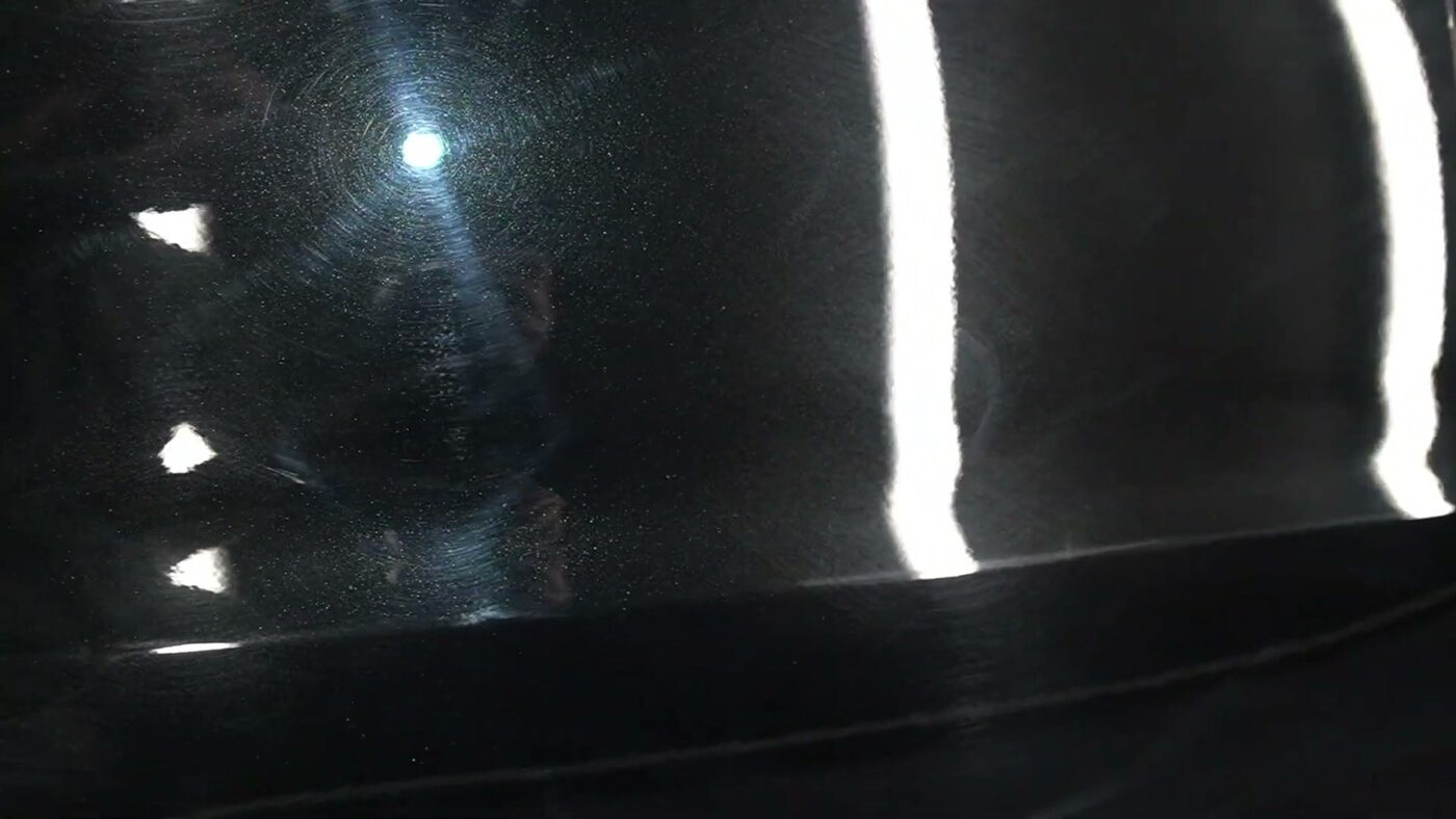 The same black paint corrected to a mirror finish