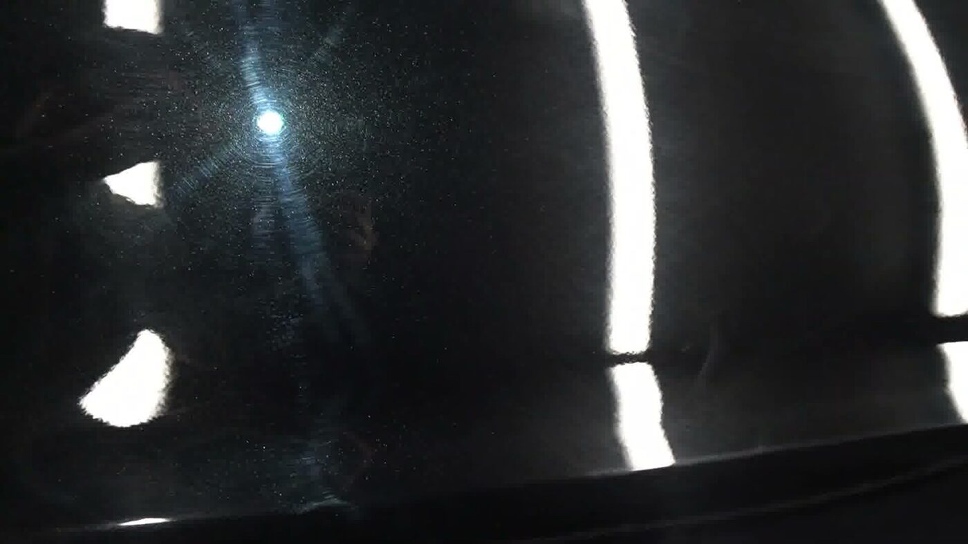 Swirled, hazy black paintwork before correction